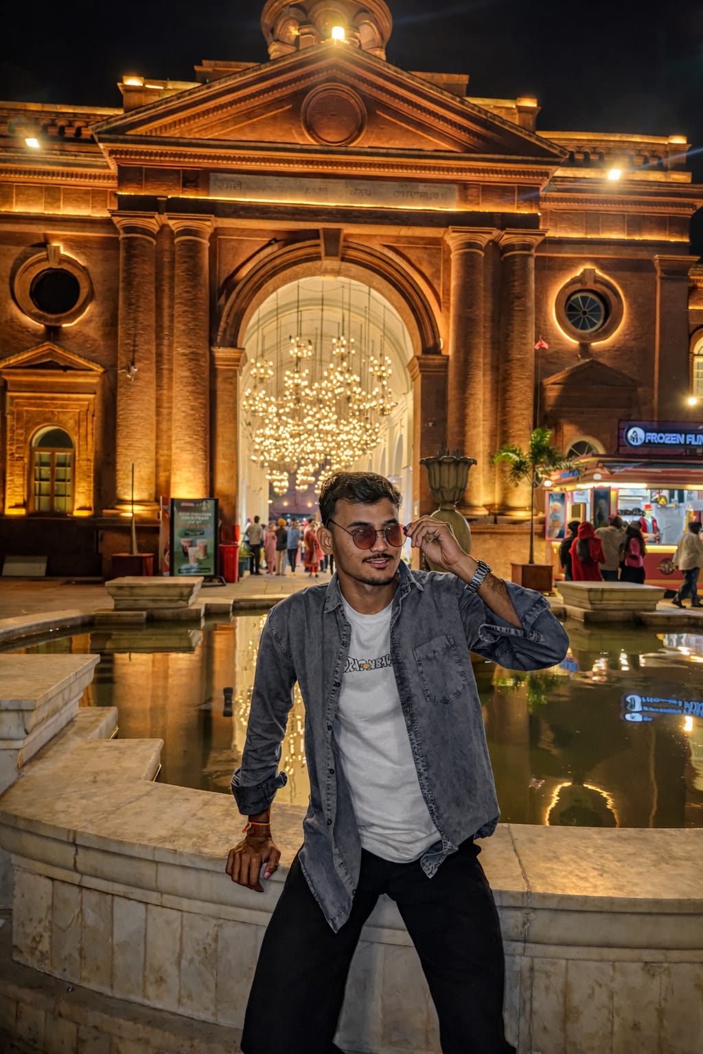 Saini Harish in front of a lit campus style building